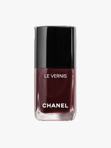 closed bottle of Chanel Le Vernis 155 on a light gray background